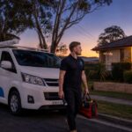 Rectify Plumbing van on Wyoming NSW street at twilight — local Central Coast emergency plumber 24/7 Gosford