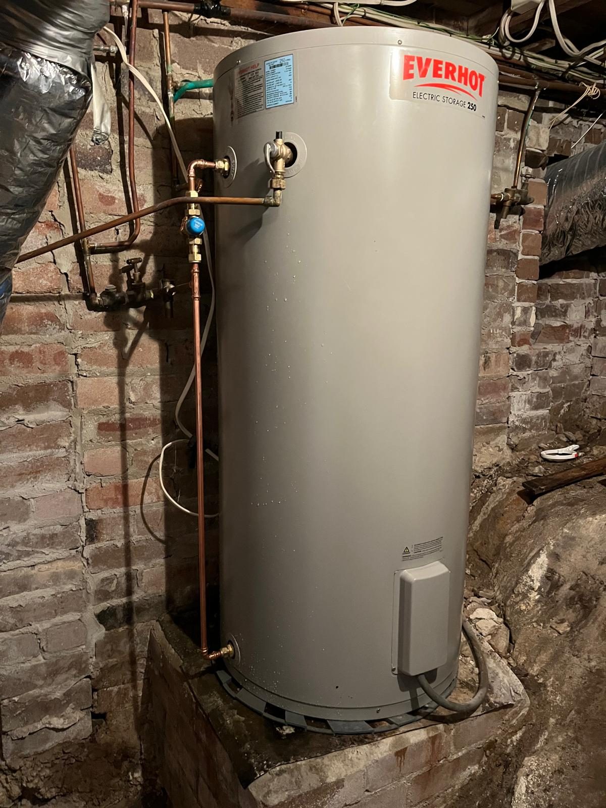 Old corroded electric hot water storage tank needing replacement in Ryde