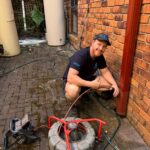 Rectify plumber feeding a drain machine cable into an external drain at an Epping home